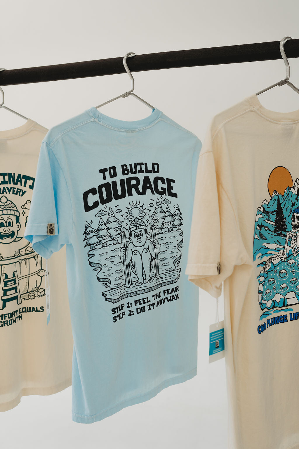 Build Courage 101Suit up with our 'Build Courage 101' tee! Featuring the bold mantra, 'Feel the fear and do it anyway,' this shirt is your go-to gear for tackling life's big leaps. WSuit up with our 'Build Courage 101' tee! Featuring the bold mantra, 'Feel the fear and do it anyway,' this shirt is your go-to gear for tackling life's big leaps. WThe Frigid CollectiveThe Frigid CollectiveBuild Courage 101